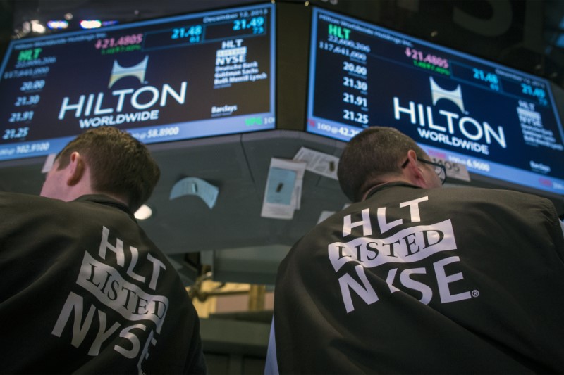 © Reuters. Traders wear special vests for the Hilton IPO on the floor of the New York Stock Exchange