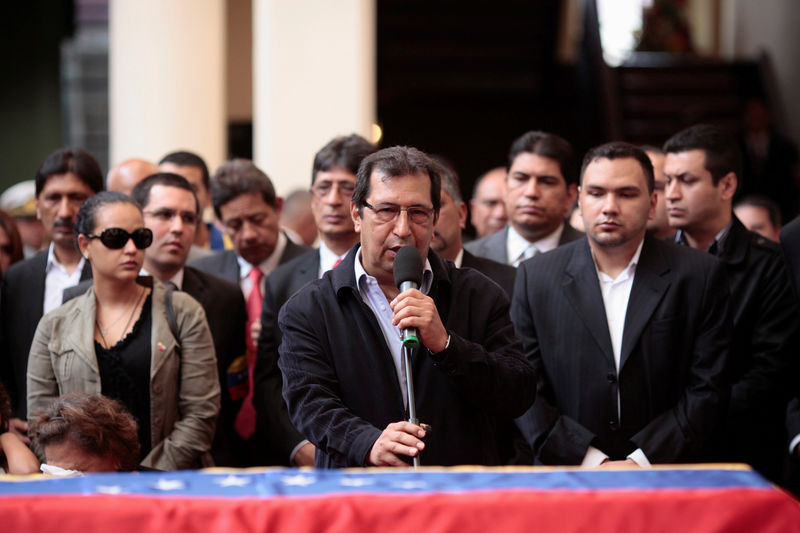 © Reuters. FILE PHOTO: Adan Chavez, brother of the Venezuela's late President Hugo Chavez, speaks next to his coffin during the funeral ceremony in Caracas