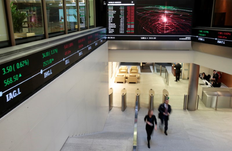 © Reuters. FILE PHOTO: People walk through the lobby of the London Stock Exchange in London