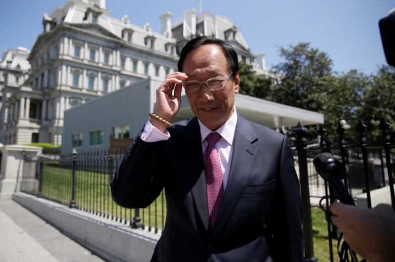 © Reuters. FILE PHOTO - Foxconn Chairman Gou talks to reporters as he exits the White House in Washington