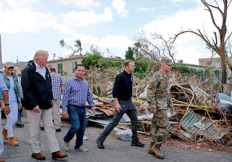 © Reuters. FILE PHOTO: President Trump and Guaynabo Mayor Angel Perez Otero walk past areas damaged by Hurricane Maria in Guaynabo Puerto Rico