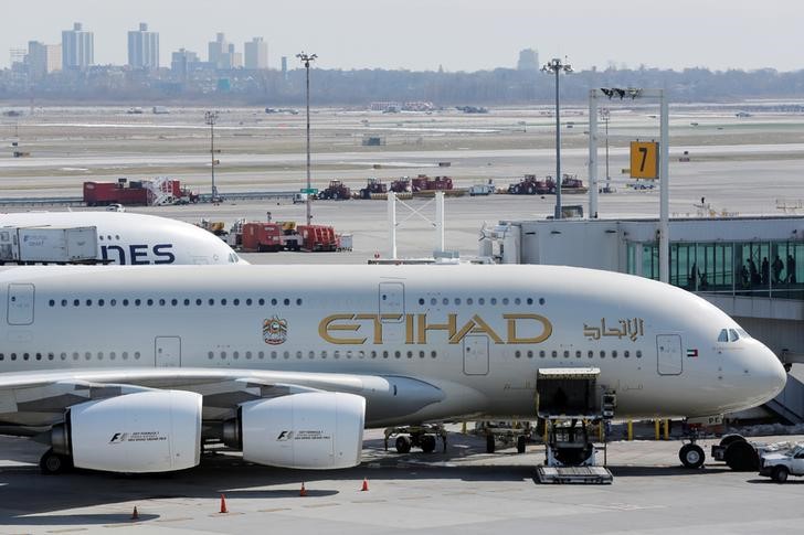 © Reuters. An Etihad plane stands parked at a gate at JFK International Airport in New York