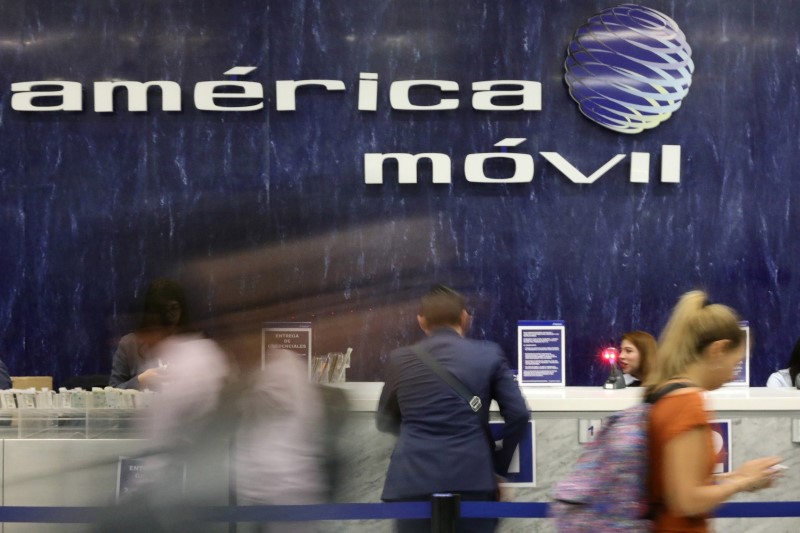 © Reuters. FILE PHOTO - The logo of America Movil is pictured on the wall of a reception area in the company's corporate offices in Mexico City