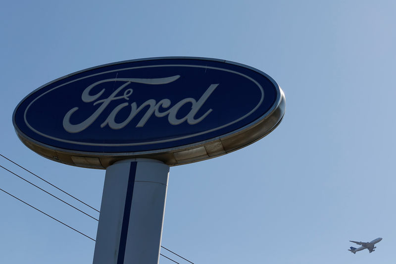 © Reuters. An airplane flies above a Ford logo in Colma, California