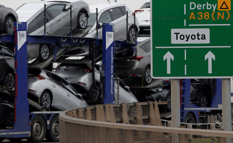 © Reuters. FILE PHOTO: New Toyota cars are transported from their manufacturing facility in Burnaston