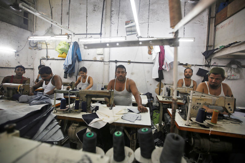 © Reuters. Employees work inside a garment factory at an industrial area in Mumbai