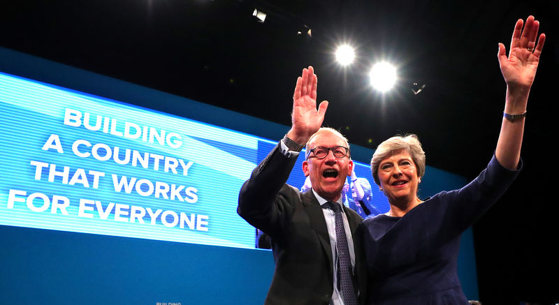 © Reuters. Britain's Prime Minister Theresa May is joined on stage by her husband Philip after she had finished addressing the Conservative Party conference in Manchester.