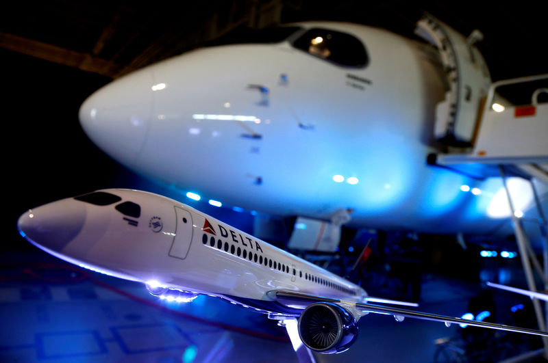 © Reuters. FILE PHOTO: A model of a Delta airplane sits in front of the Bombardier CS100 aircraft after a news conference announcing a contract with Delta Air Lines, at Bombardier's hangar in Mirabel