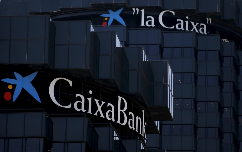© Reuters. CaixaBank and LaCaixa's logos are seen at the company's headquarters in Barcelona