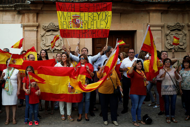 © Reuters. People hold Spanish flags during a pro-union gathering in Ronda