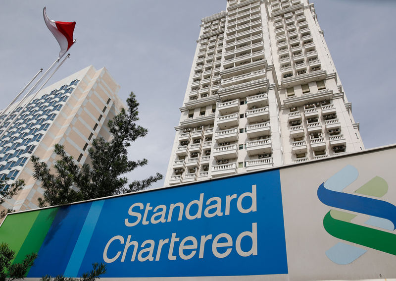 © Reuters. FILE PHOTO: A Standard Chartered sign is seen outside of a building, with a branch of the bank, in Jakarta, Indonesia