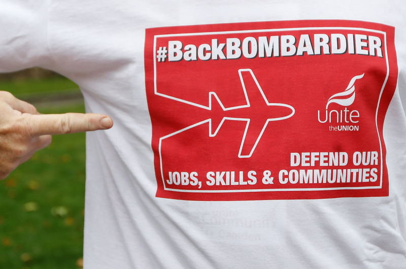 © Reuters. Member of Britain's Unite trade union presents a t-shirt with slogans during a protest outside the Houses of Parliament in support of Bombardier workers in London