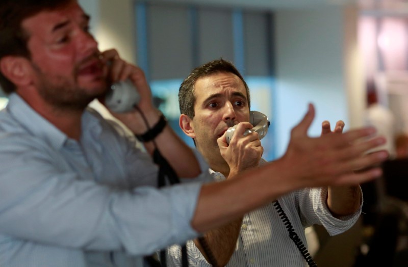 © Reuters. Traders from BGC, a global brokerage company in London's Canary Wharf financial centre react as European stock markets open