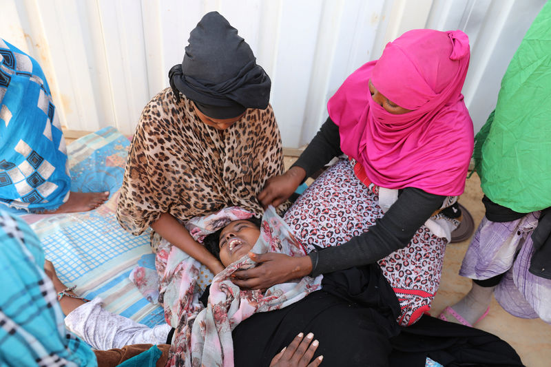 © Reuters. A migrant is attended at a detention center in Gharyan