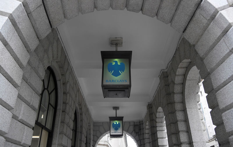 © Reuters. FILE PHOTO:The logo of Barclays bank is seen on glass lamps outside of a branch of the bank in the City of London financial district in London