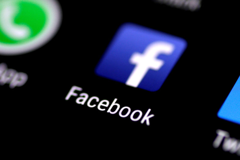 © Reuters. FILE PHOTO: The Facebook application is seen on a phone screen