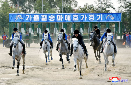 © Reuters. People take part in a horse riding game at the Mirim Equestrian Riding Club in Pyongyang