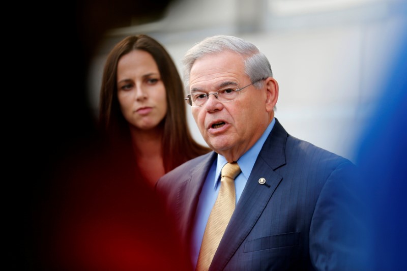 © Reuters. FILE PHOTO: Senator Bob Menendez speaks to journalists after arriving to face trial for federal corruption charges as his children Alicia Menendez looks on outside United States District Court for the District of New Jersey in Newark