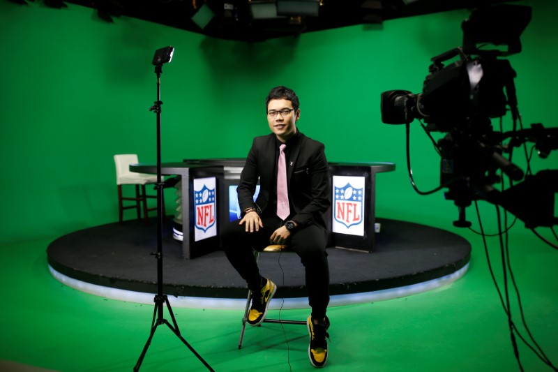 © Reuters. Chinese commentator Wang Zixing poses for a picture after broadcasting a live commentary of a NFL American football game in a studio of the media and gaming firm Tencent Holdings in Beijing