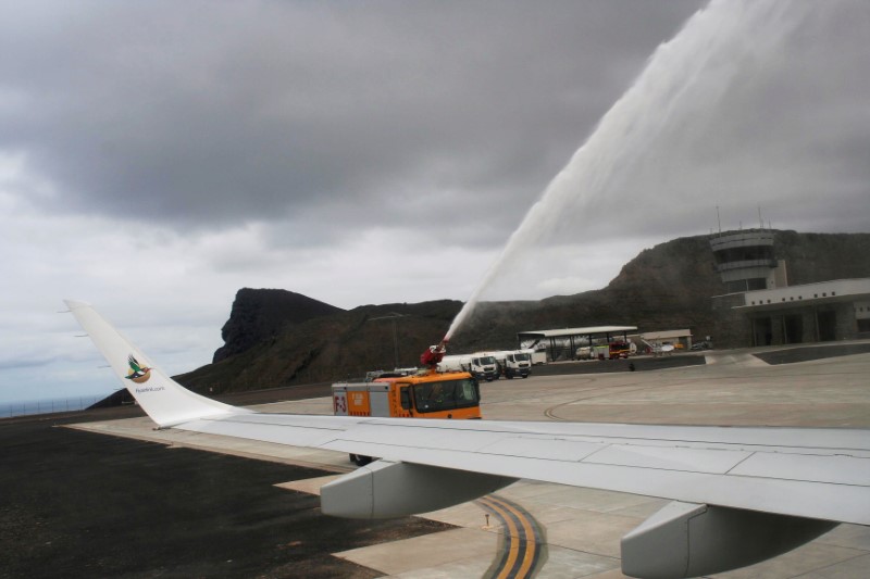 © Reuters. A fire truck sprays water over the first ever commercial flight to land at St Helena airport near Jamestown