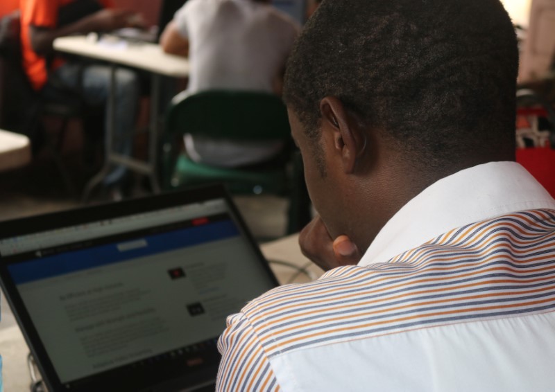 © Reuters. Young startup promoters work on their computers in New Bonako village