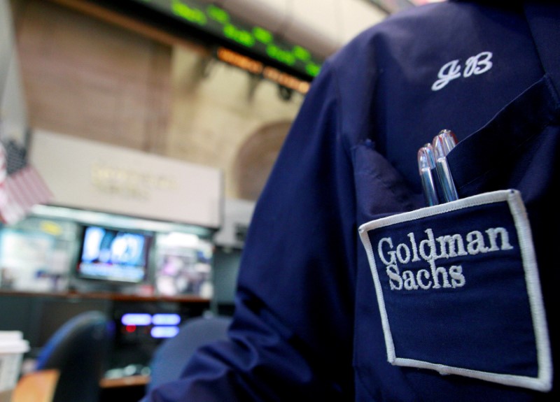 © Reuters. FILE PHOTO: A trader works at the Goldman Sachs stall on the floor of the New York Stock Exchange