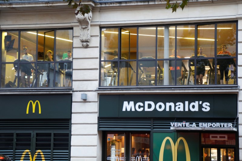 © Reuters. People practice at a fitness club located on top a McDonald's restaurant in Paris