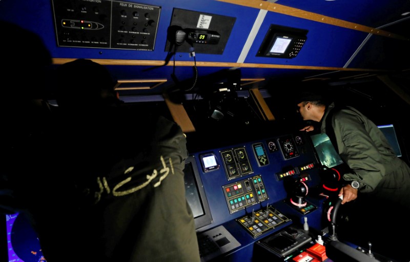 © Reuters. Tunisian coast guard officers sail on a boat while patrolling off the coast of Bizerte