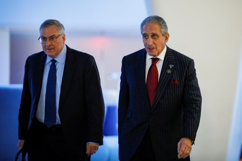 © Reuters. Buffalo Bills owner Terry Pegula and Atlanta Falcons owner Arthur Blank arrive together for the NFL owners meeting in New York City