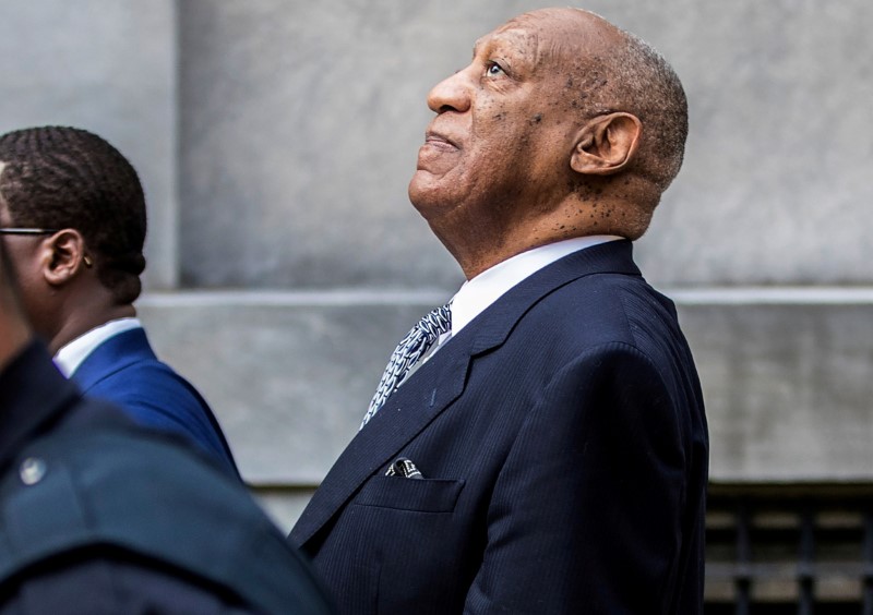 © Reuters. FILE PHOTO: Bill Cosby leans back to listens to words of encouragement from onlookers outside Montgomery County Courthouse in Norristown