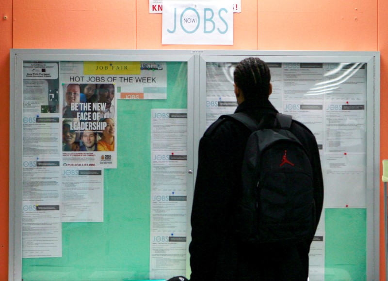 © Reuters. FILE PHOTO: A man looking at employment opportunities at a jobs center in San Francisco