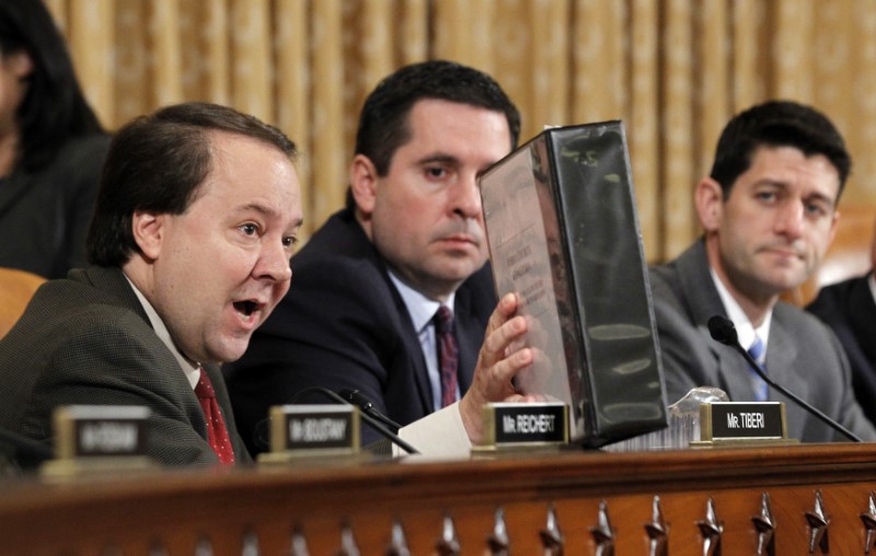 © Reuters. U.S. Representative Pat Tiberi (R-OH) holds a folder from a conservative group, the Ohio Liberty Coalition, as he questions outgoing acting IRS Commissioner Steven Miller at a House Ways and Means Committee hearing on the Internal Revenue Service targeting conservative groups on Capitol Hill in Washington May 17, 2013.