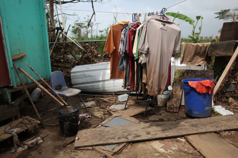 © Reuters. Clothes are seen on a rack outside a home, after Hurricane Maria hit the island in September, in Toa Baja