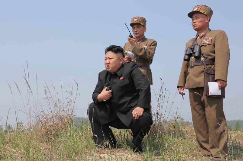 © Reuters. FILE PHOTO: North Korean leader Kim Jong Un guides the multiple-rocket launching drill of women's sub-units under KPA Unit 851