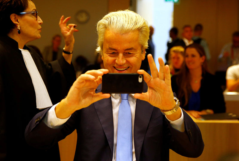 © Reuters. Dutch far-right politician Geert Wilders of the PVV Party photographs the press in the courthouse in Schiphol