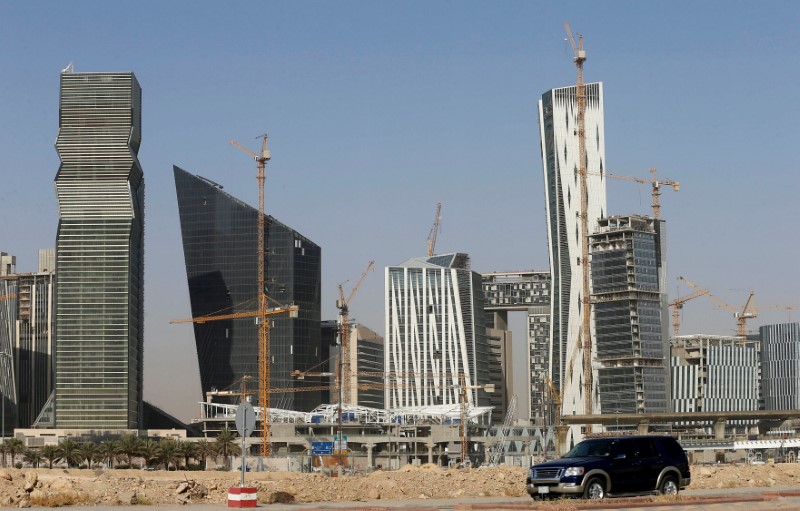 © Reuters. FILE PHOTO:A vehicle drives past the King Abdullah Financial District in Riyadh