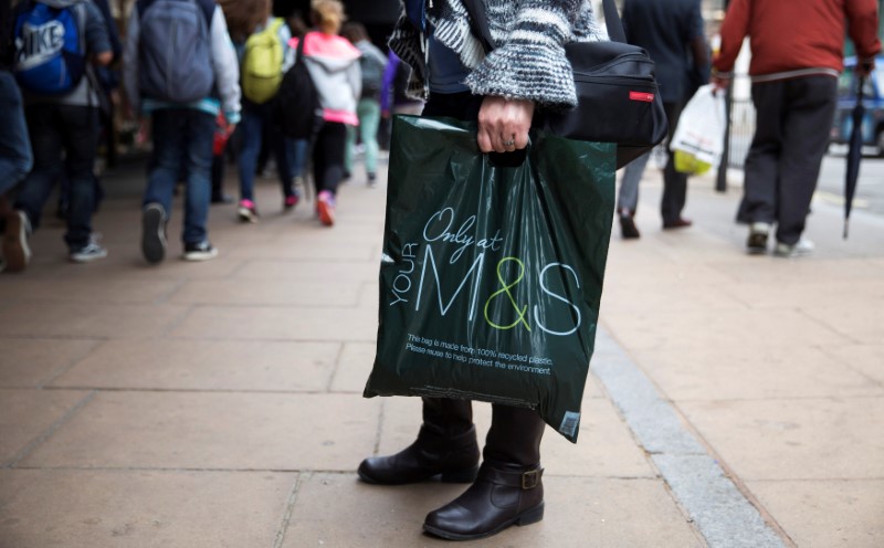 © Reuters. FILE PHOTO: A shopper carries a Marks and Spencer bag in central London, Britain