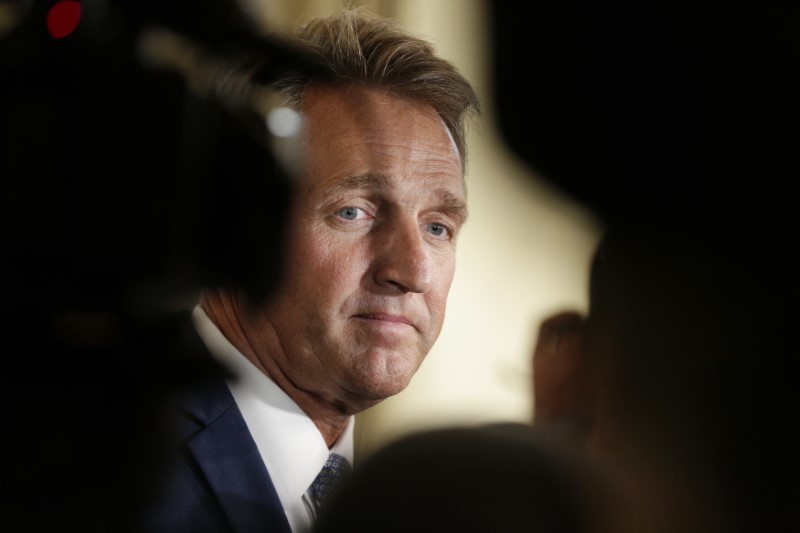 © Reuters. U.S. Senator Flake faces reporters after announcing he will not run for reelection on Capitol Hill in Washington