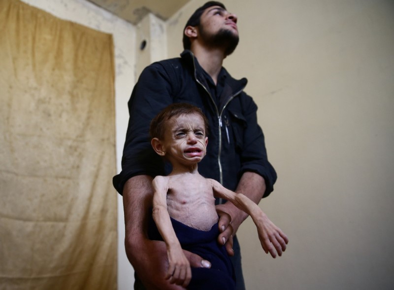 © Reuters. A Picture and its Story: 'At the doors of starvation:' siege chokes Damascus suburbs