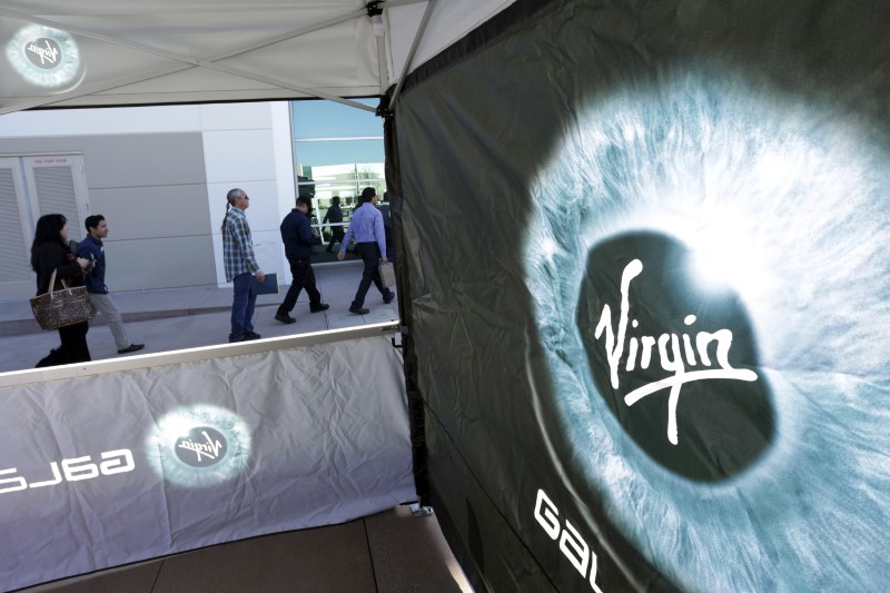 © Reuters. FILE PHOTO:  People attend a job fair at a new Virgin Galactic and The Spaceship Company facility in Long Beach