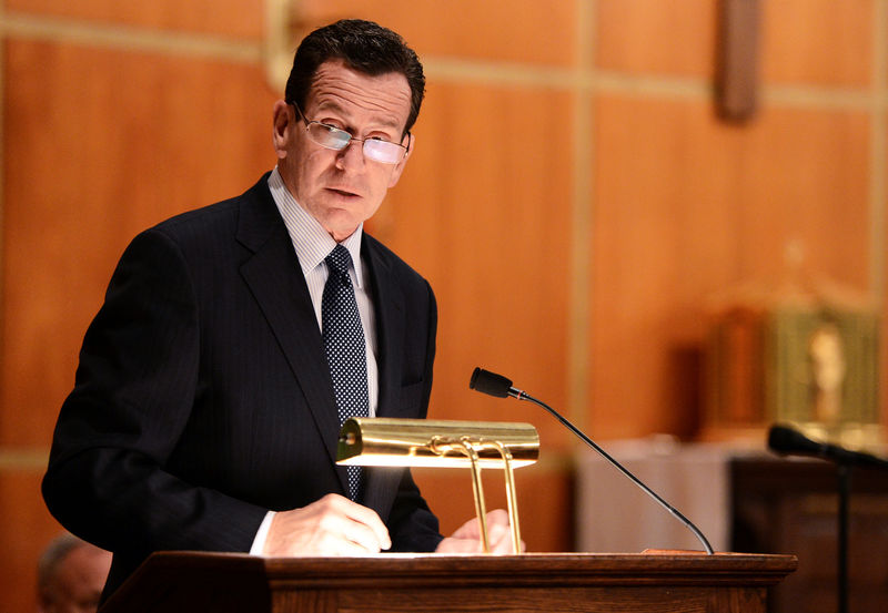 © Reuters. FILE PHOTO: Dannel Malloy, Governor of Connecticut speaks to mourners gathererd inside the St. Rose of Lima Roman Catholic Church