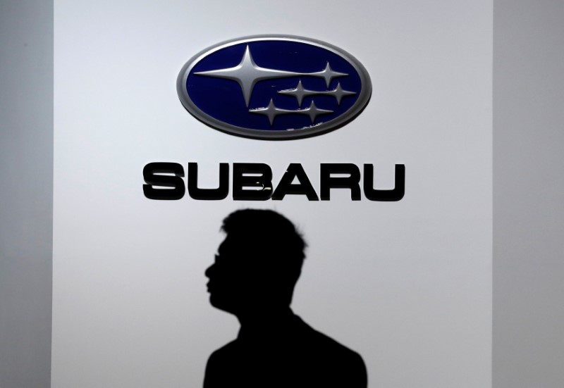 © Reuters. A man walks past the logo of Subaru Corp at the 45th Tokyo Motor Show in Tokyo