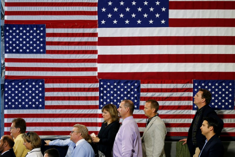 © Reuters. People listen as U.S. President Donald Trump speaks about tax reform in Harrisburg, Pennsylvania