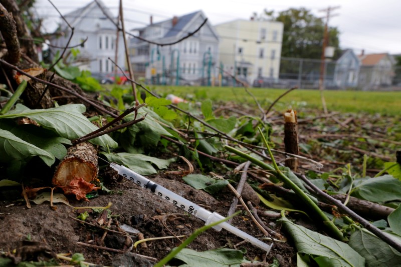 © Reuters. FILE PHOTO: A used needle sits on the ground in a park in Lawrence