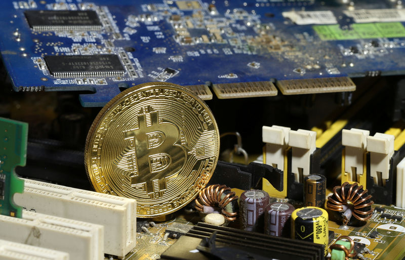 © Reuters. A copy of bitcoin standing on PC motherboard is seen in this illustration picture