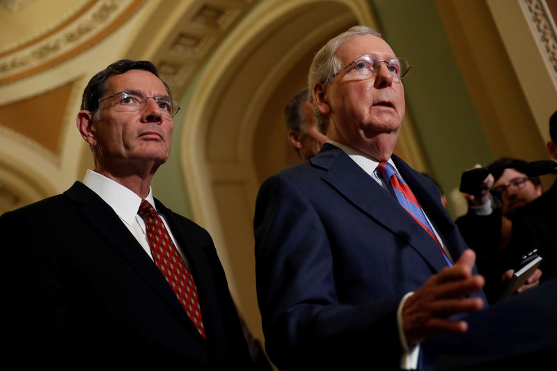 © Reuters. Senate Majority Leader Mitch McConnell, accompanied by Sen. John Barrasso (R-WY), speaks with reporters following the party luncheons on Capitol Hill in Washington