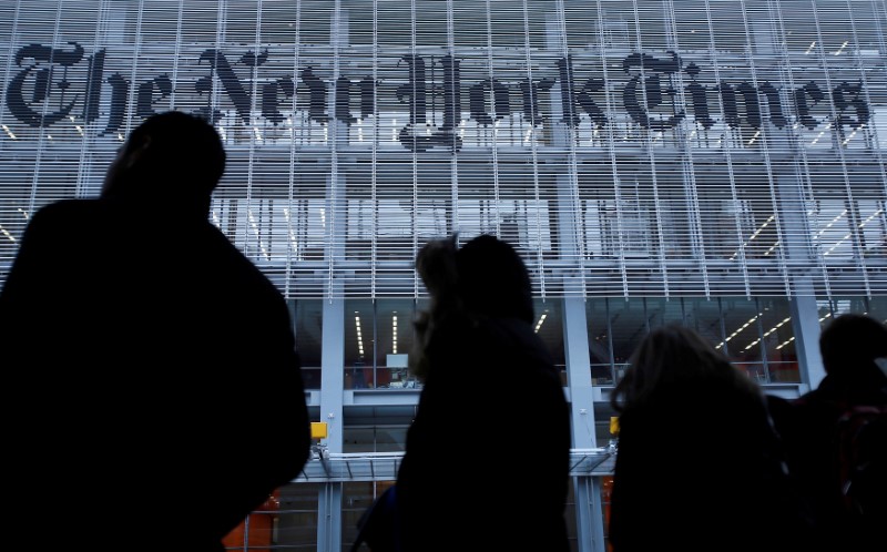 © Reuters. FILE PHOTO: People line up for taxi across the street from the New York Times head office in New York