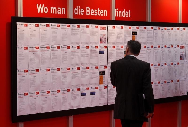 © Reuters. Man reads job offers during the first day of Hannover Messe industrial trade fair in Hanover