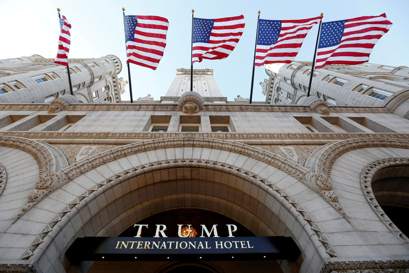 © Reuters. FILE PHOTO: Flags fly above the entrance to the new Trump International Hotel on its opening day in Washington