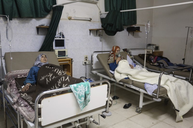 © Reuters. People, affected by what activists say was a gas attack, receive treatment inside a makeshift hospital in Kfar Zeita village in Hama